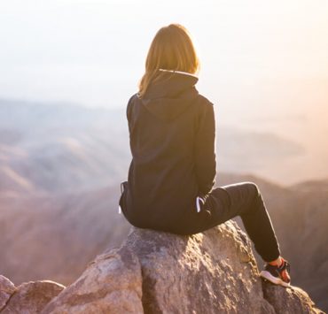 women on rock taking a break