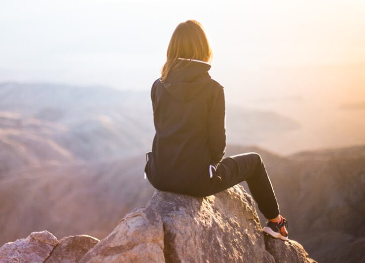 women on rock taking a break