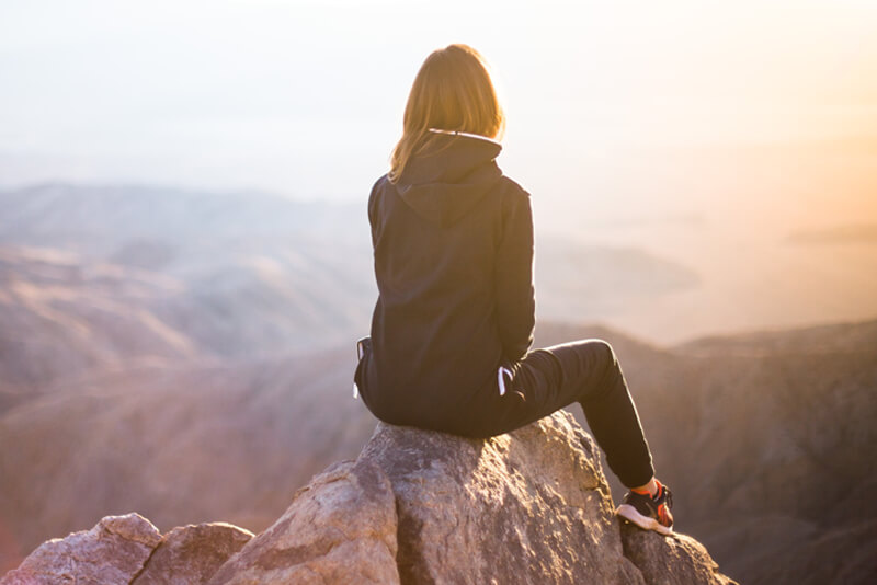 women on rock taking a break
